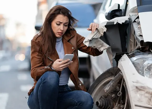 young-sad-woman-text-messaging-smart-after-car-crash-road copy
