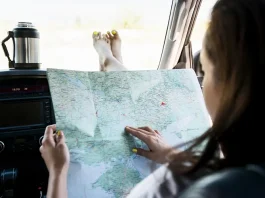 a woman holding a map in the car