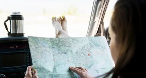 Ways to Maximize Your Experience When Traveling on a Budget a woman holding a map in the car