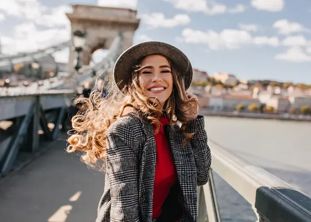enchanting-lady-with-gorgeous-curly-hair-posing-with-pleasure-bridge-windy-day copy