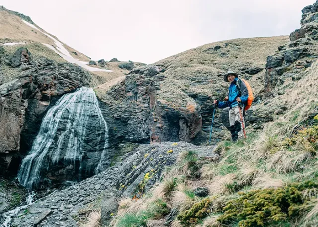 senior-asian-hiker-near-the-waterfall-active-seni-2026-01-11-08-52-35-utc copy