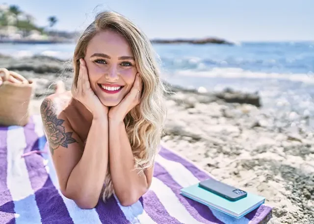 young-blonde-girl-wearing-bikini-lying-towel-beach copy