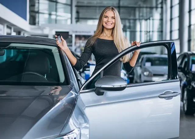 young-woman-choosing-car-car-showroom copy