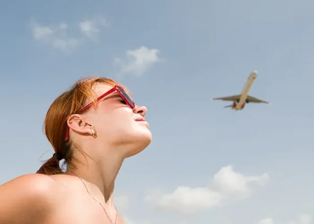young-woman-looking-airplane copy
