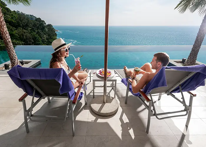 couple-infinity-poolside-while-sitting-sun-loungers copy