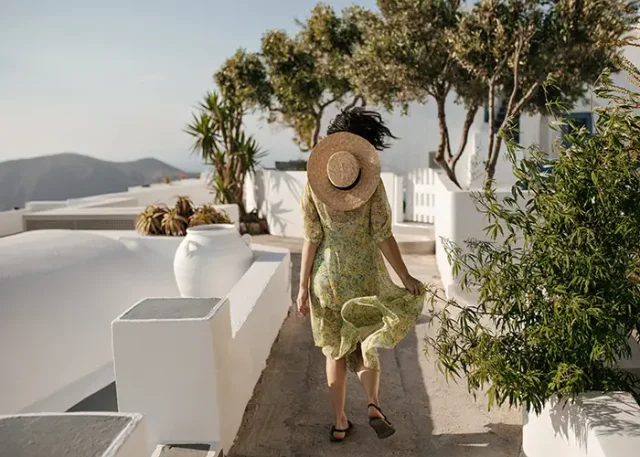 curly-short-haired-woman-floral-dress-boater-runs-outside copy