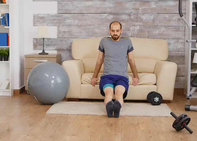fit-guy-training-triceps-sofa-home-wearing-sportswear copy