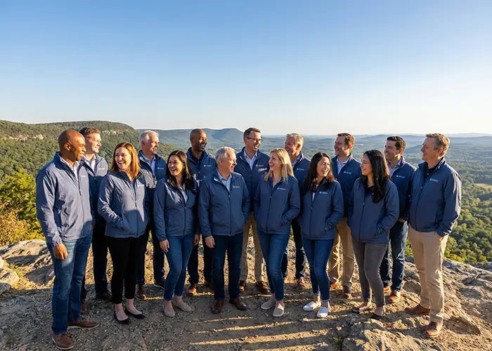 group of people in matching jackets on scenic overlook