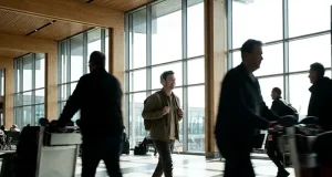 5 Small Habits for Smoother Travel Days People walking in an airport terminal with large windows.