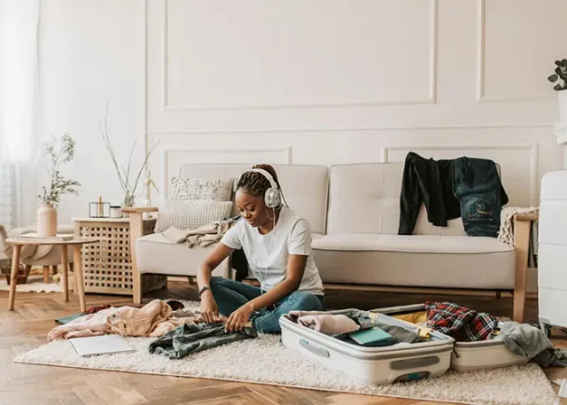 a woman in the middle of packing for Dubai
