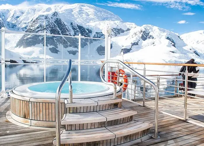 The hot tub on deck - Heritage Discoverer expedition ship with a remote polar landscape
