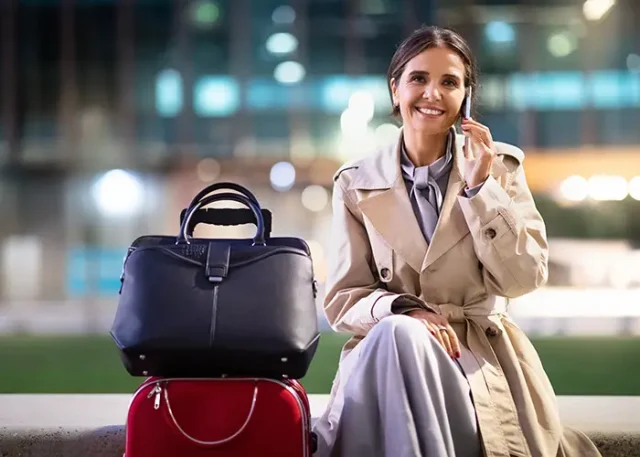 attractive-mature-business-woman-sitting-airport-have-phone-call copy