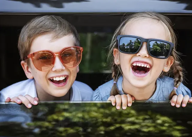 happy-kids-looking-out-car-window copy
