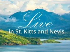 Why St. Kitts and Nevis Is Emerging as One of the World’s Most Desirable Places to Relocate Scenic tropical coastline and mountains of St. Kitts and Nevis with the words “Live in St. Kitts and Nevis.”