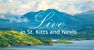 Why St. Kitts and Nevis Is Emerging as One of the World’s Most Desirable Places to Relocate Scenic tropical coastline and mountains of St. Kitts and Nevis with the words “Live in St. Kitts and Nevis.”