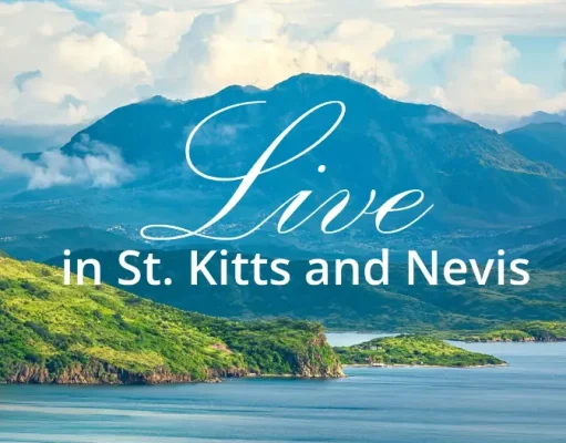 Why St. Kitts and Nevis Is Emerging as One of the World’s Most Desirable Places to Relocate Scenic tropical coastline and mountains of St. Kitts and Nevis with the words “Live in St. Kitts and Nevis.”