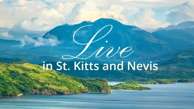 Scenic tropical coastline and mountains of St. Kitts and Nevis with the words “Live in St. Kitts and Nevis.”