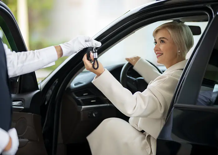 woman-exchanging-car-keys-with-parking-valet copy