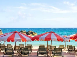 Pink-sand beach and striped umbrellas at Palmetto Beach Club in Bermuda