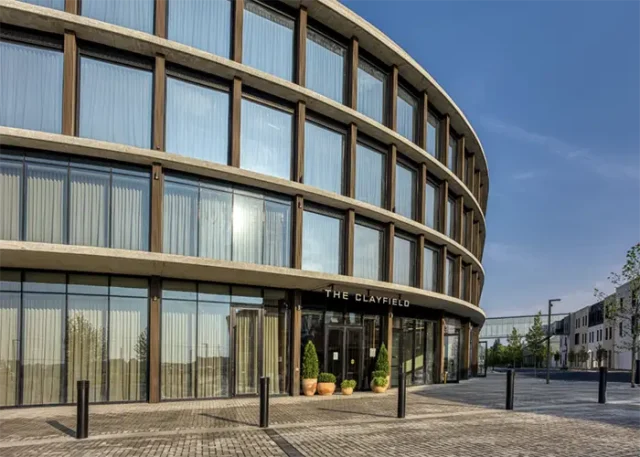 Curved glass exterior and main entrance of The Clayfield hotel in Niagara-on-the-Lake, Ontario