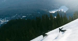Why LAAX Deserves a Place on Your Swiss Ski Shortlist Skier and snowboarder descending a snowy slope at LAAX ski resort in the Swiss Alps