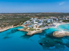 Before you turn a Cyprus holiday into a Cyprus address: what each residence route requires Aerial view of ayia napa coastline with nissi beach and resorts