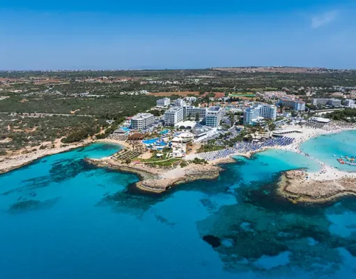 Before you turn a Cyprus holiday into a Cyprus address: what each residence route requires Aerial view of ayia napa coastline with nissi beach and resorts