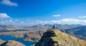Killary Fjord Named One of Lonely Planet’s Best Travel Experiences for 2027 Walker on the South Ridge of Mweelrea Mountain overlooking Killary Fjord in County Mayo, Ireland, with panoramic views of mountains, lakes, and dramatic coastal landscapes.
