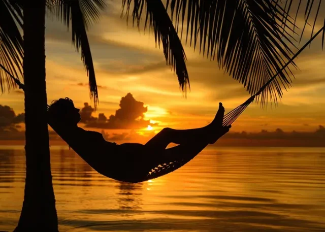silhouette-person-relaxing-hammock-sun-set-tropical-beach copy