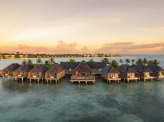 Kuda Villingili Resort Maldives Earns Place in the MICHELIN Guide Hotel Collection 2026 Aerial view of Kuda Villingili Resort Maldives, featuring luxury overwater villas and turquoise waters in North Malé Atoll.