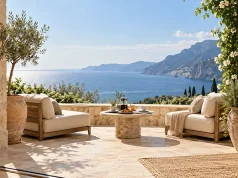 The Enduring Appeal of Elegant Travel Sunlit luxury terrace with cream seating and coffee for two overlooking the Mediterranean Sea