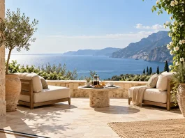 Sunlit luxury terrace with cream seating and coffee for two overlooking the Mediterranean Sea