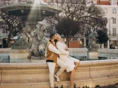 Lisbon Itinerary: How to Spend 3 Days in Lisbon Couple sitting on the rim of the baroque fountain in Rossio square, Lisbon