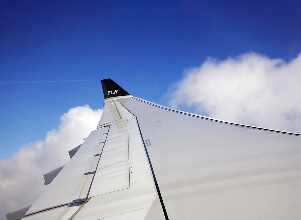 NADI, FIJI - DEC 11 2016:Fiji Airways Boeing 737-800 wing.Fiji Airways serves 24 direct-flight destinations in the Pacific Ocean region.