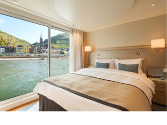 Bedroom in an Veranda Suite onboard the Viking Longship Hlin with the town of Lorch am Rhein in the Upper Middle Rhine Valley in Germany out the window