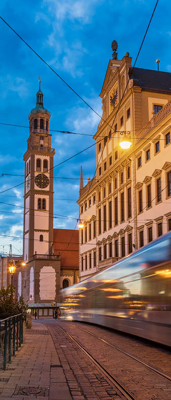 Augsburg cityscape with tram moving along the Maximilianstrasse, Perlach Tower (Perlachturm) and Town Hall (Augsburger Rathaus) seen in background, Augsburg, Swabia, Bavaria, Germany