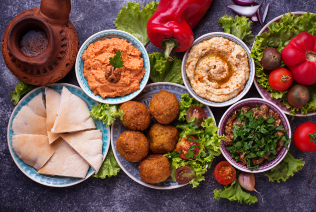 Selection of Middle eastern or Arabic dishes  Falafel, hummus, pita and  muhammara  Top view