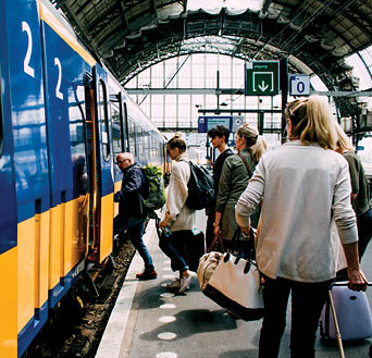A group of friends getting on the train in Amsterdam.