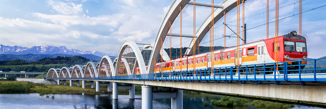 Suburb passenger train drive through the viaduct towards the Tatra Mountains, Poland