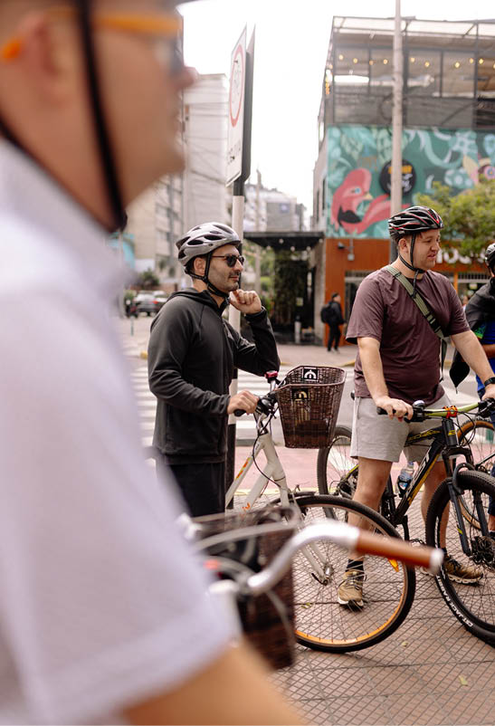 A man wearing a helmet and glasses is talking on his cell phone. Description generated by AI