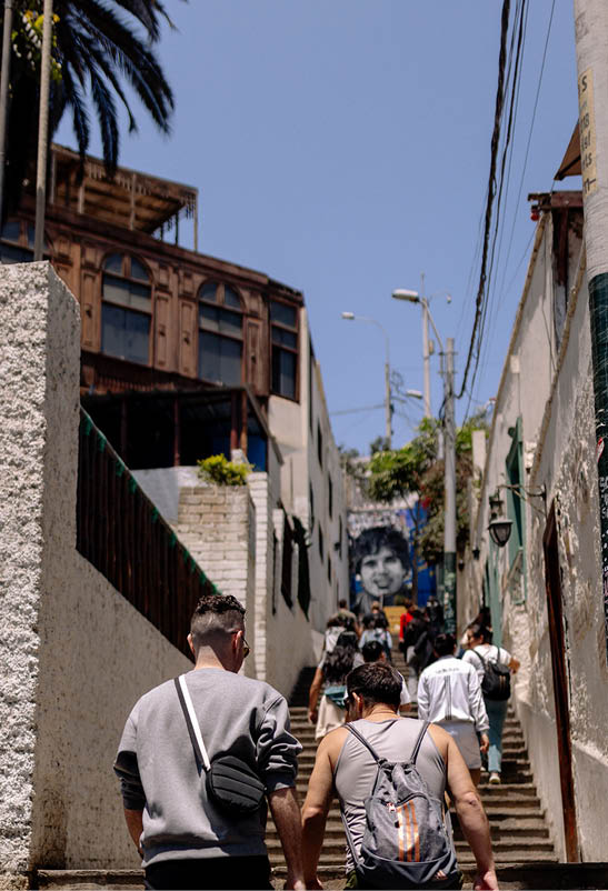 A man and woman walking up a flight of stairs. Description generated by AI