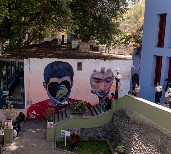 A mural of a man with a bird on his shoulder. Description generated by AI