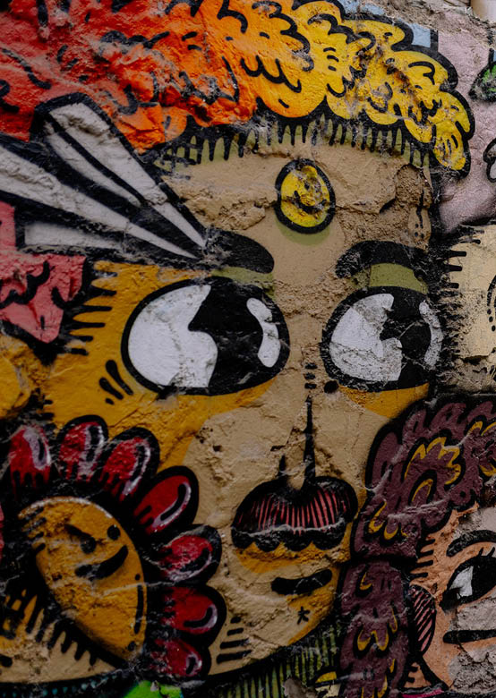 A wall with graffiti on it. Description generated by AI