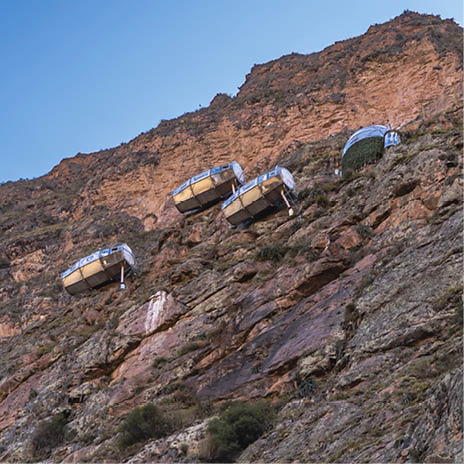 A rocky mountain with a group of people standing on top of it. Description generated by AI