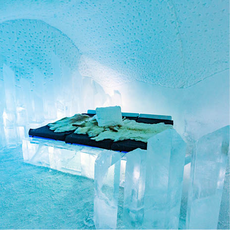 A bed made of ice with a white cover on it. Description generated by AI