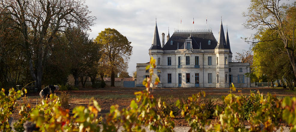 A large white building with a red roof and blue trim. Description generated by AI