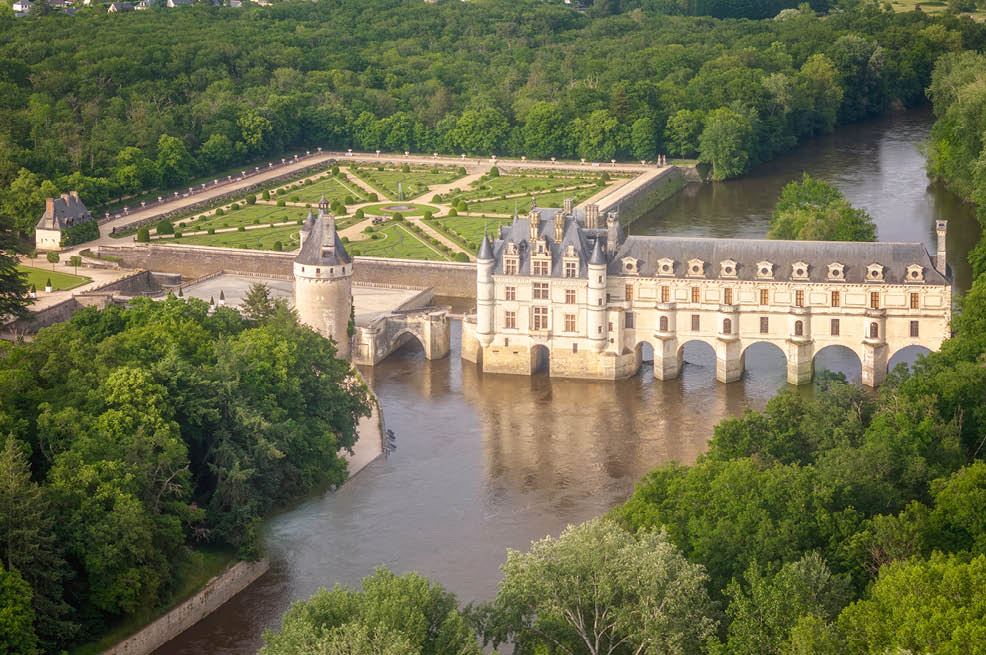 A large castle with a moat and a bridge. Description generated by AI