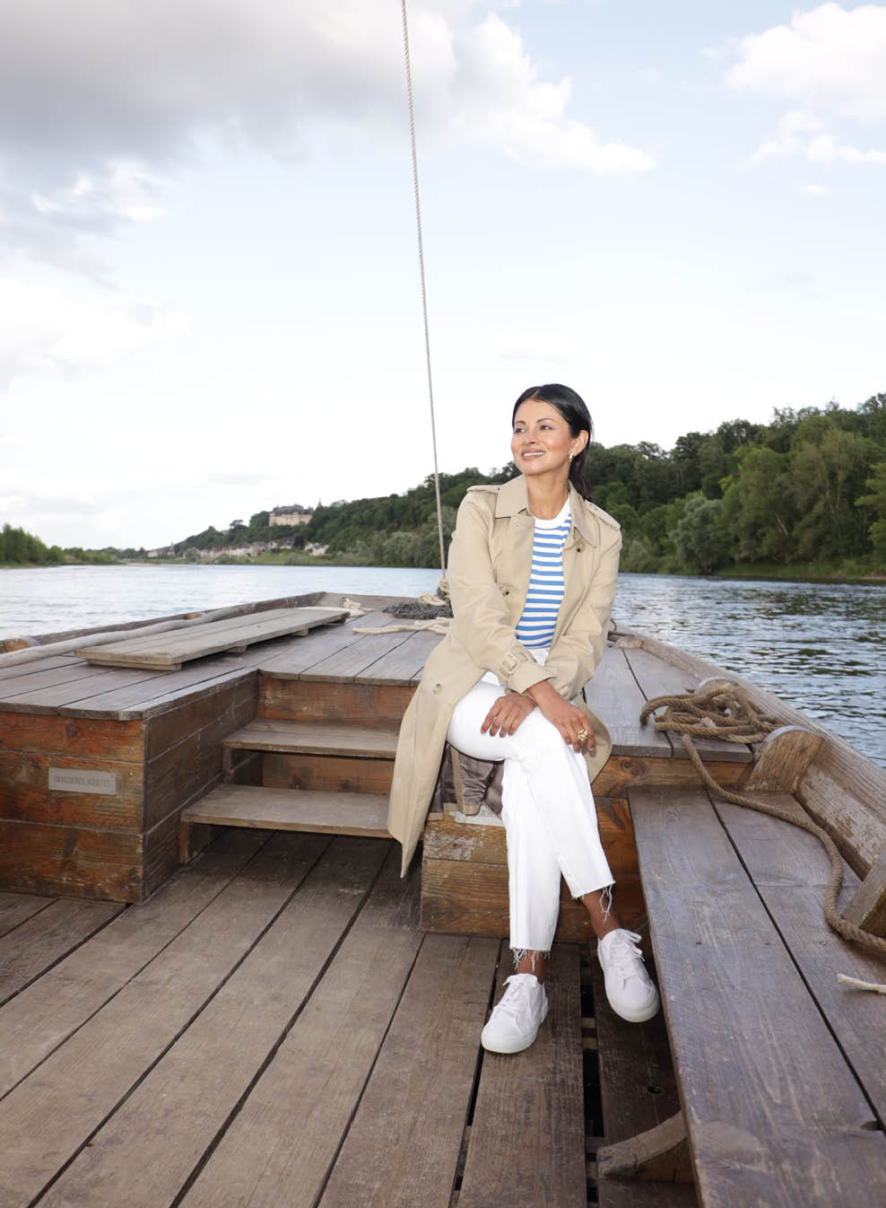 A woman sitting on a boat. Description generated by AI