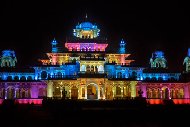 A large building with a blue, yellow, and pink roof. Description generated by AI