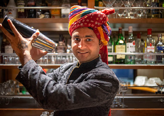 A man wearing a turban and a black jacket. Description generated by AI